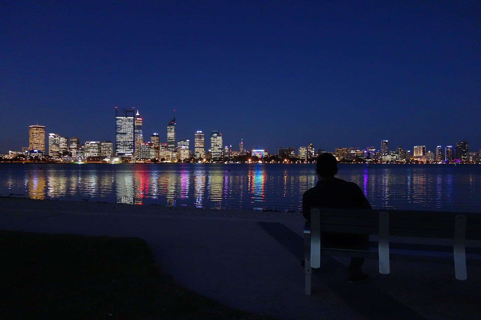 The Perth city skyline at night across the Swan River